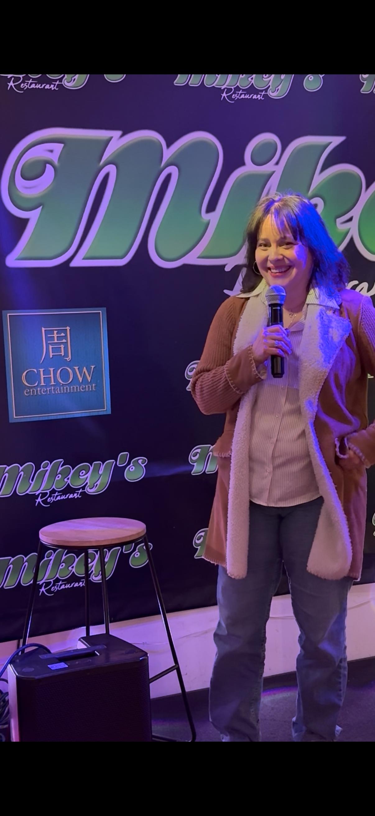 Suzanna Brown on the mic during a clean stand-up set